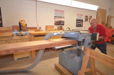 Piece of mahogany 19 ft. long pushed through the planer a number of times to prepare the piece to make the stem.